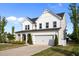 Gorgeous exterior elevation featuring a two-story layout, a front porch with seating, and well-maintained landscaping at 128 Highland Grove Way, Fuquay Varina, NC 27526