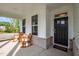 Inviting front porch with comfortable rocking chairs, views of the neighborhood, and a stylish entrance door at 128 Highland Grove Way, Fuquay Varina, NC 27526