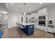 Stylish kitchen features a spacious island, white cabinetry, and pendant lighting, ideal for entertaining guests at 128 Highland Grove Way, Fuquay Varina, NC 27526