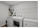 Functional laundry room with modern washer, dryer, and storage shelving at 128 Highland Grove Way, Fuquay Varina, NC 27526