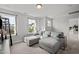 Cozy living area featuring a comfortable gray sectional sofa with bright, natural light at 128 Highland Grove Way, Fuquay Varina, NC 27526