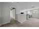 Bright open loft area with neutral tones, carpeted floor, and view to the lower living area at 128 Highland Grove Way, Fuquay Varina, NC 27526