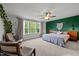 Spacious primary bedroom features large windows, stylish decor, and comfortable seating area at 128 Highland Grove Way, Fuquay Varina, NC 27526