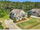 An aerial view of a two-story home with a well-manicured lawn and a concrete driveway at 128 Paraggi Ct, Clayton, NC 27527