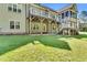 Back exterior showcasing deck, covered patio, stairs, screened porch and nice lawn at 128 Paraggi Ct, Clayton, NC 27527