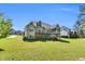 Back exterior showcasing deck, covered patio, stairs, screened porch and expansive lawn at 128 Paraggi Ct, Clayton, NC 27527
