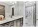Bathroom with wainscoting, vanity with drawers, and shower curtain with a floral pattern and white tile at 128 Paraggi Ct, Clayton, NC 27527