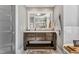 Bathroom featuring a dark wood vanity, white marble countertop, large mirror, and walk-in shower at 128 Paraggi Ct, Clayton, NC 27527