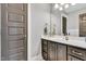 Well-lit bathroom with sleek vanity, modern fixtures, and neutral gray color palette at 128 Paraggi Ct, Clayton, NC 27527