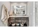 Bathroom featuring a dark wood vanity, white marble countertop, large mirror, and under-cabinet storage at 128 Paraggi Ct, Clayton, NC 27527