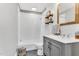 Bathroom featuring a shower/tub combination, white subway tile, and wooden shelves at 128 Paraggi Ct, Clayton, NC 27527