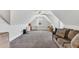 Finished bonus room or attic space providing extra living area with a pitched roof and ceiling fan at 128 Paraggi Ct, Clayton, NC 27527