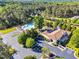 Aerial view of community clubhouse and pool, surrounded by lush landscaping and parking at 128 Paraggi Ct, Clayton, NC 27527