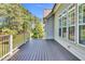 Spacious deck with gray wood flooring and white railings overlooking the backyard at 128 Paraggi Ct, Clayton, NC 27527