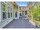 Spacious deck with gray wood flooring and white railings connecting to stairs and screened porch at 128 Paraggi Ct, Clayton, NC 27527