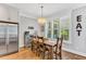 Casual dining area featuring hardwood floors, shuttered windows, and a modern light fixture at 128 Paraggi Ct, Clayton, NC 27527