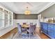 Elegant dining room with hardwood floors, tray ceiling, and stylish blue accent cabinet at 128 Paraggi Ct, Clayton, NC 27527