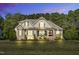 Charming two-story home featuring stone accents, a covered front porch and mature trees at 128 Paraggi Ct, Clayton, NC 27527