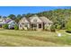 Charming two-story home with a lush green lawn and manicured landscaping at 128 Paraggi Ct, Clayton, NC 27527