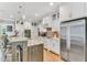 Modern kitchen with marble countertops, stainless steel appliances, and island seating at 128 Paraggi Ct, Clayton, NC 27527
