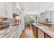 Well-lit kitchen with marble countertops, stainless steel appliances, and eat-in bar area at 128 Paraggi Ct, Clayton, NC 27527