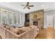 Spacious living room boasting stone fireplace, built-in shelving, and comfortable sectional seating at 128 Paraggi Ct, Clayton, NC 27527
