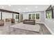 Basement living room featuring a comfortable couch, stylish rug, and natural lighting at 128 Paraggi Ct, Clayton, NC 27527