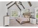 Light filled main bedroom with a vaulted ceiling, exposed beams, a large window, and a tufted headboard at 128 Paraggi Ct, Clayton, NC 27527