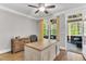 Bright office featuring a large desk, hardwood floors, and access to an outdoor screened-in porch at 128 Paraggi Ct, Clayton, NC 27527