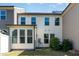 View of the back of the townhome showcasing large windows and a well maintained lawn at 1314 Catch Fly Ln, Durham, NC 27713