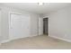 Neutral bedroom featuring carpet, a closet, a ceiling light and a doorway at 1314 Catch Fly Ln, Durham, NC 27713