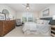 Well-lit bedroom featuring a dresser, a comfortable chair, and large windows that provide natural light at 1314 Catch Fly Ln, Durham, NC 27713