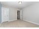 A carpeted bedroom with a walk-in closet; the laundry room is visible through a doorway at 1314 Catch Fly Ln, Durham, NC 27713
