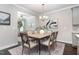 Dining room with hardwood floors, stylish light fixtures and adjacent living spaces at 1314 Catch Fly Ln, Durham, NC 27713