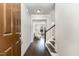 Inviting entryway with dark wood floors, staircase, and a view into the bright living room at 1314 Catch Fly Ln, Durham, NC 27713