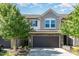 Charming townhome featuring stone accents, a two-car garage, and a well-maintained front yard at 1314 Catch Fly Ln, Durham, NC 27713