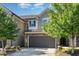 Townhome featuring a stone and gray shingle exterior with a two-car garage at 1314 Catch Fly Ln, Durham, NC 27713