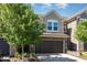 Charming townhome featuring a stone and gray shingle exterior with a two-car garage at 1314 Catch Fly Ln, Durham, NC 27713