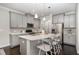 Modern kitchen featuring gray cabinets, quartz countertops, stainless steel appliances, and a kitchen island at 1314 Catch Fly Ln, Durham, NC 27713