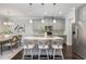 Kitchen with island seating, stainless steel appliances, pendant lighting and view to the dining area at 1314 Catch Fly Ln, Durham, NC 27713