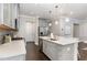 Well-equipped kitchen with gray cabinets, stainless steel appliances, and a spacious island at 1314 Catch Fly Ln, Durham, NC 27713
