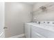 Laundry room featuring tile floor, a washer and dryer, and wire shelving at 1314 Catch Fly Ln, Durham, NC 27713