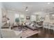 Open concept living room with hardwood floors, natural light, and seamless flow to dining and kitchen areas at 1314 Catch Fly Ln, Durham, NC 27713