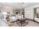 Spacious living room with hardwood floors, natural light, and open concept design to the kitchen and dining area at 1314 Catch Fly Ln, Durham, NC 27713