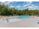 Community pool surrounded by lounge chairs and lush greenery at 1314 Catch Fly Ln, Durham, NC 27713