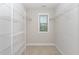 A functional walk-in closet with shelving and a window to let in natural light at 1314 Catch Fly Ln, Durham, NC 27713