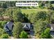 Stunning home with golf course views surrounded by lush greenery and mature trees at 1401 Marshall Farm St, Wake Forest, NC 27587