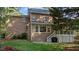 Backyard view of the home, showcasing a brick exterior, screened porch and well-manicured lawn at 1401 Marshall Farm St, Wake Forest, NC 27587
