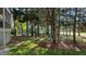 Secluded backyard with lush trees, a black iron fence, and manicured grass providing a peaceful outdoor space at 1401 Marshall Farm St, Wake Forest, NC 27587