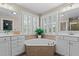 Bathroom featuring double vanities, soaking tub and plantation shutters at 1401 Marshall Farm St, Wake Forest, NC 27587